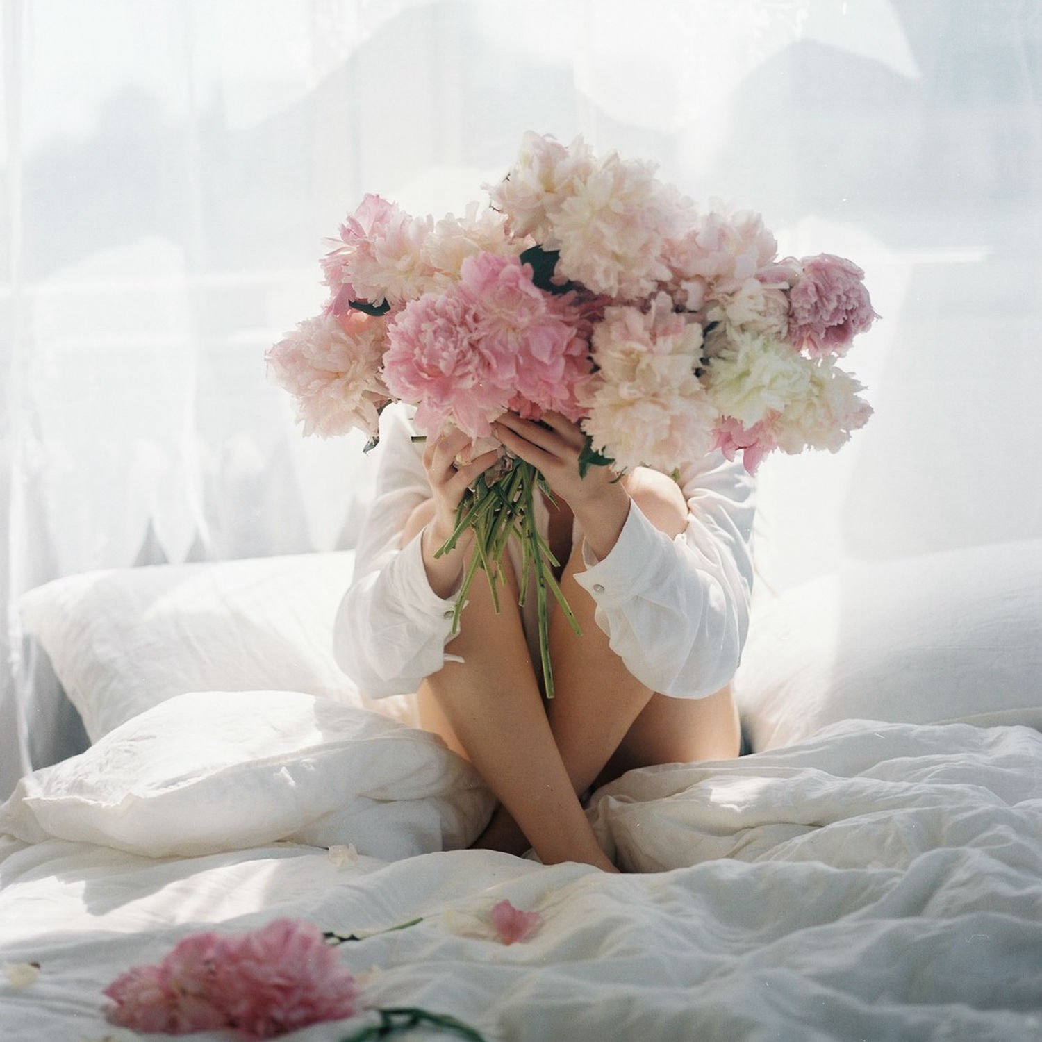 Chronic fatigue testimonial Woman in a white shirt holding a mug by the window, symbolising calm and improved wellbeing through hormone health support